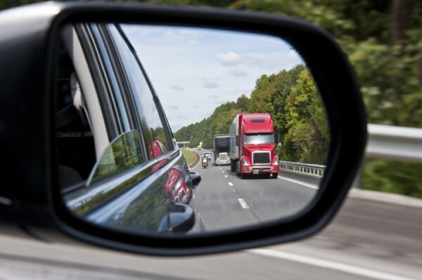 semi-truck in rearview mirror truck crash steps to take