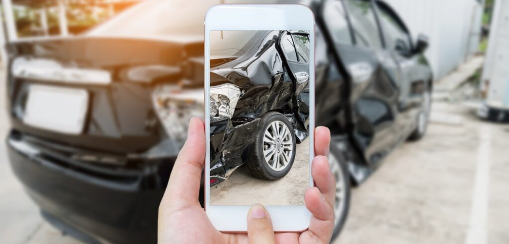 Oakland City Driver Using Smartphone Photographing Car Accident
